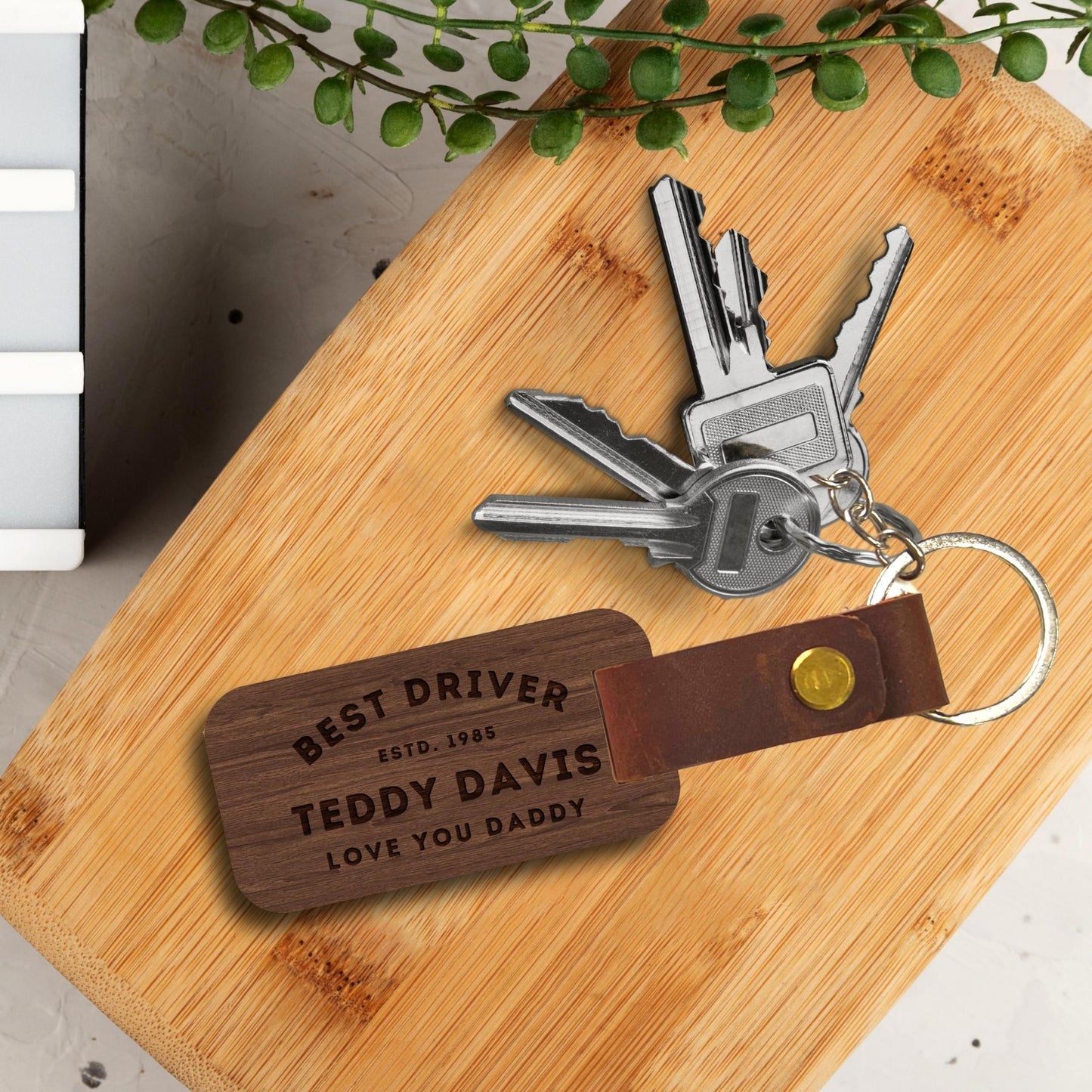 Engraved wood & leather keychain, close-up of custom text. Image 2 of 10.